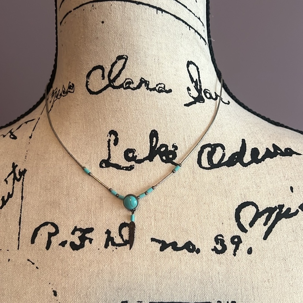 Silver and turquoise necklace with feather drop detail